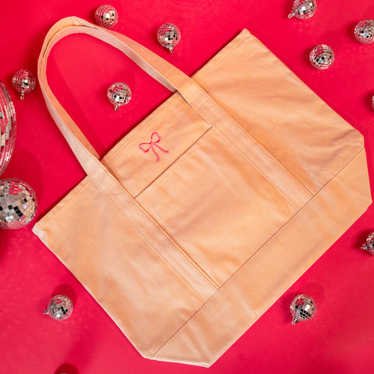 beige tote with little pink bow