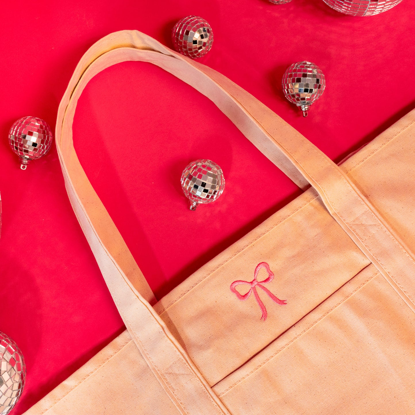 pink bow on beige tote