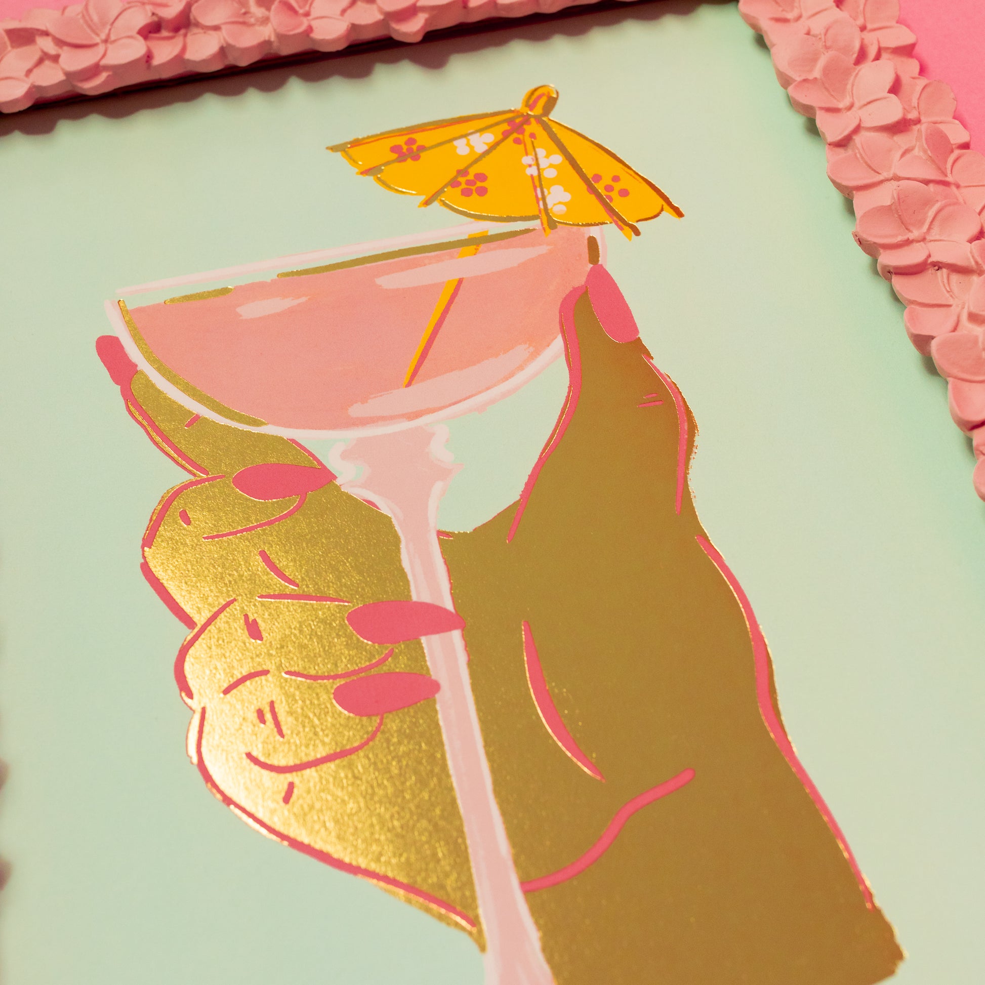 pink cocktail glass and gold hand