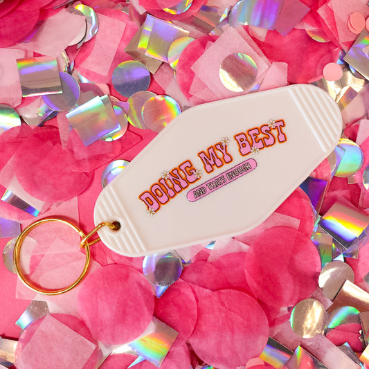 white keychain with pink words