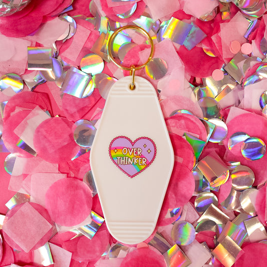 white keychain with purple heart and rainbow