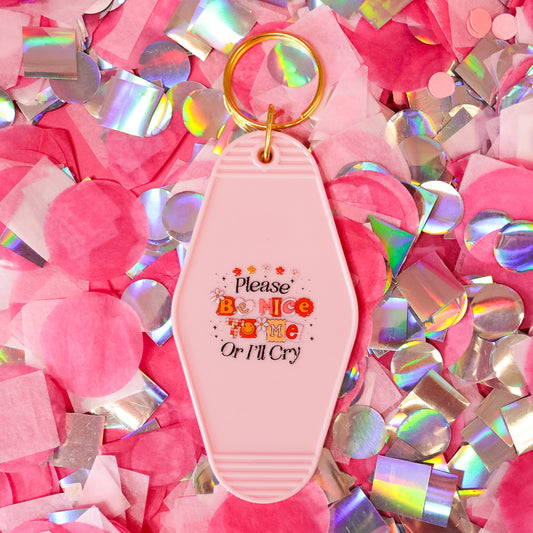 pink keychain with black words