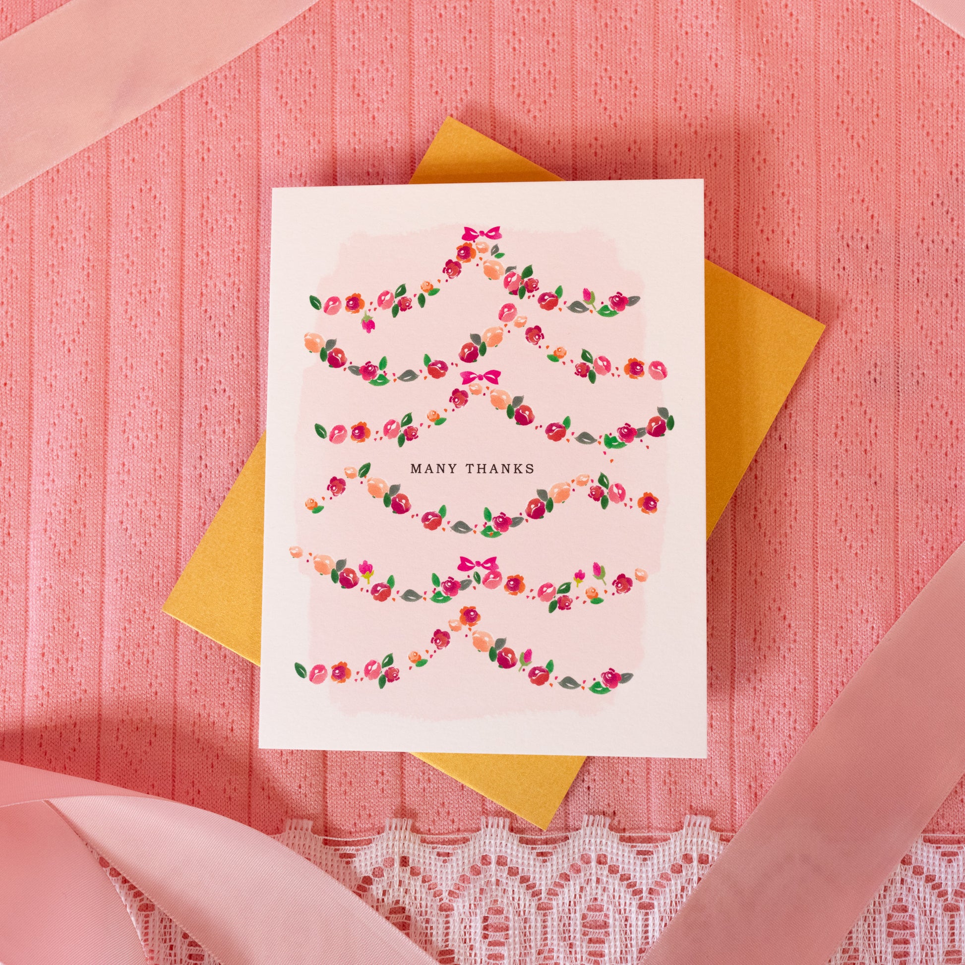 white card with pink and red garland