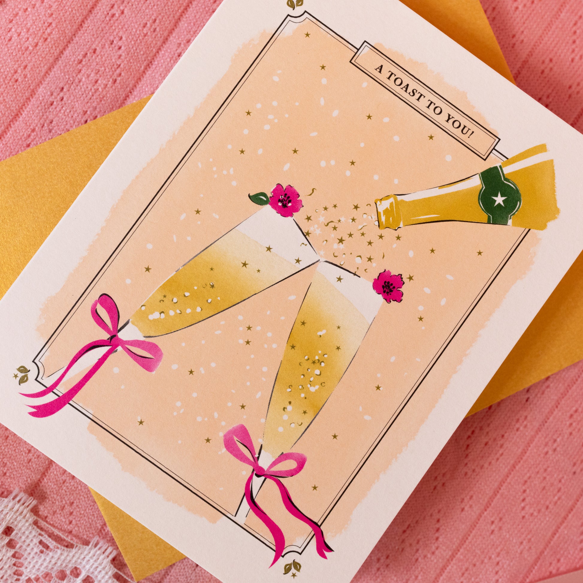 champagne glasses with pink bows and flowers