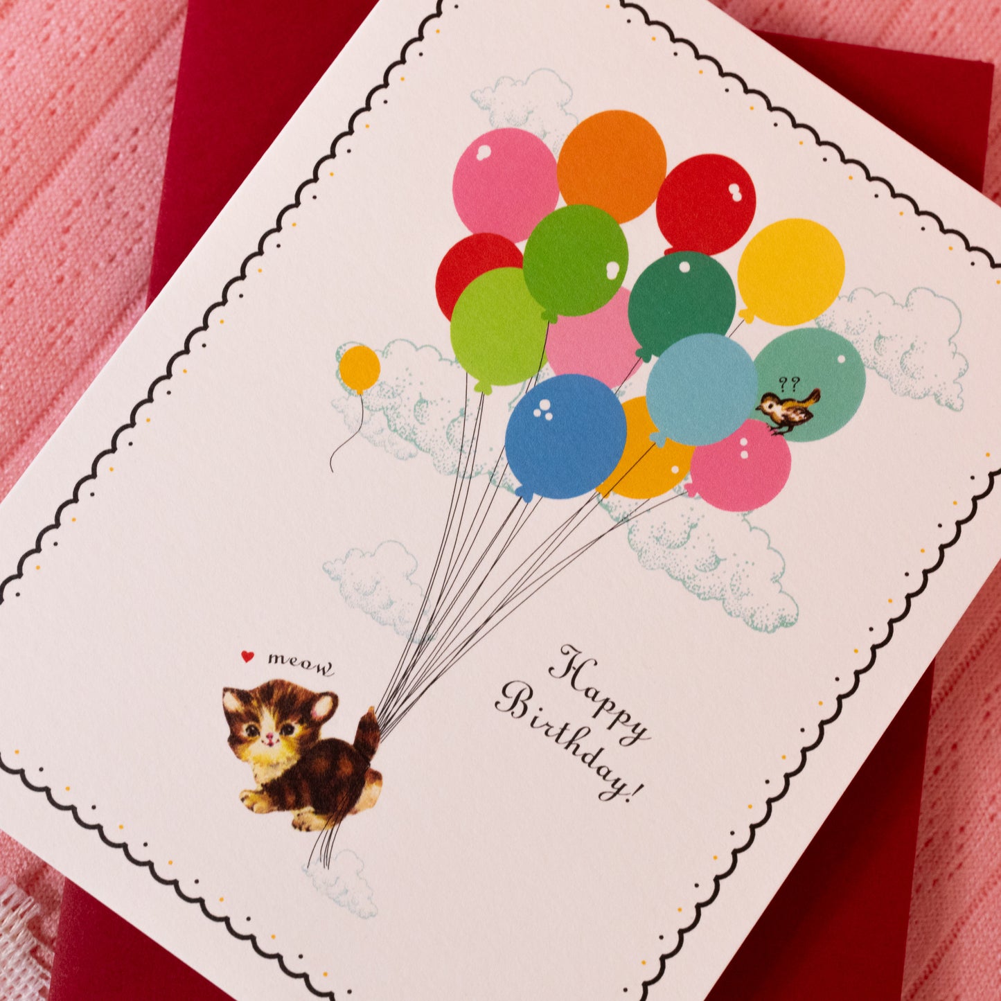 white card with red, orange, yellow, pink, green and blue balloons