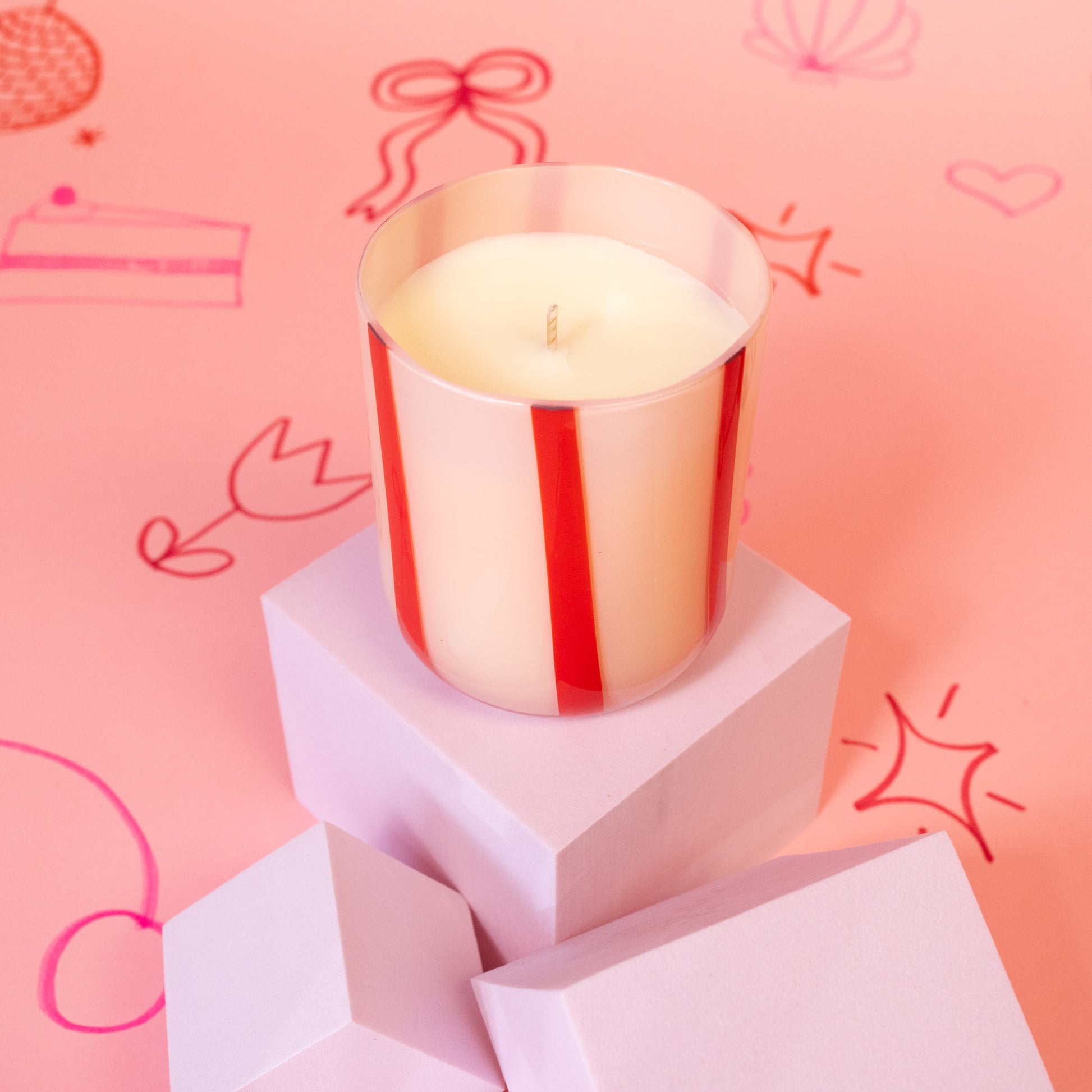 white candle with red stripes