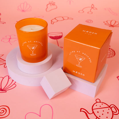 orange candle with white tired of wellness