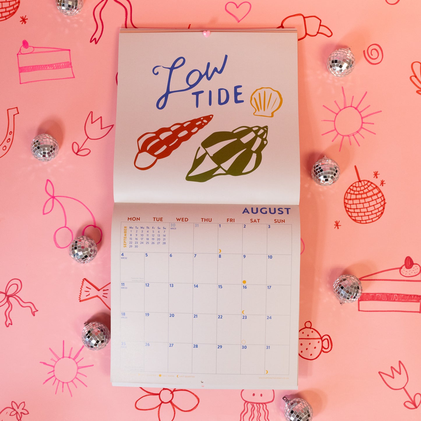 blue words and colorful shells on white calendar