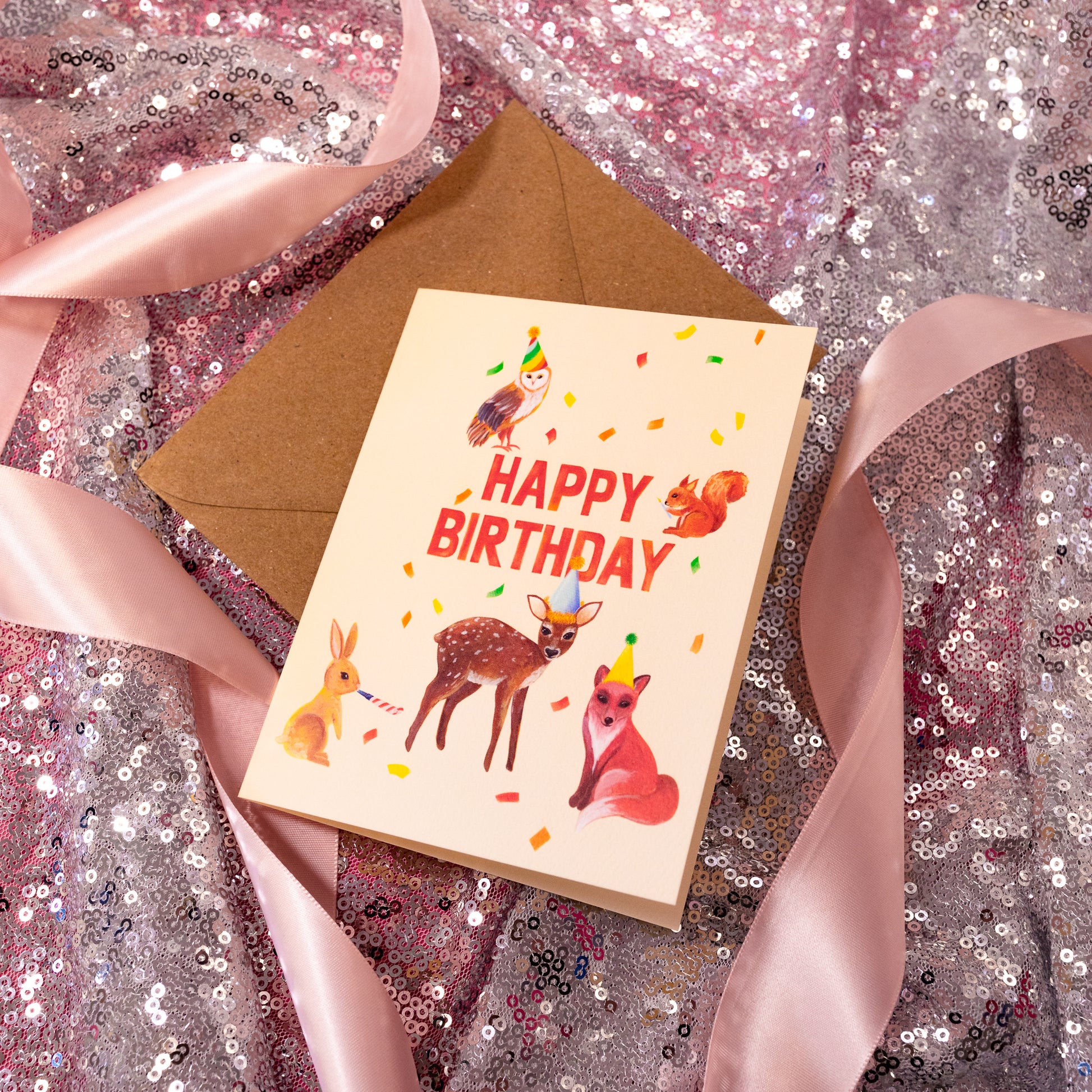 beige card with confetti and animals