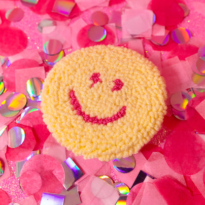 yellow and pink smiley face car coaster