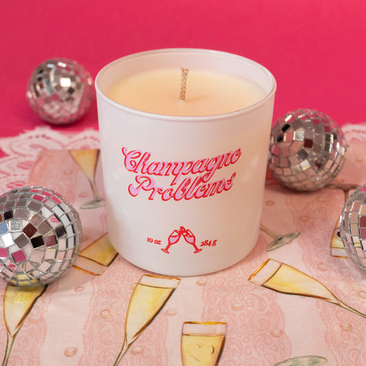 white candle with pink words