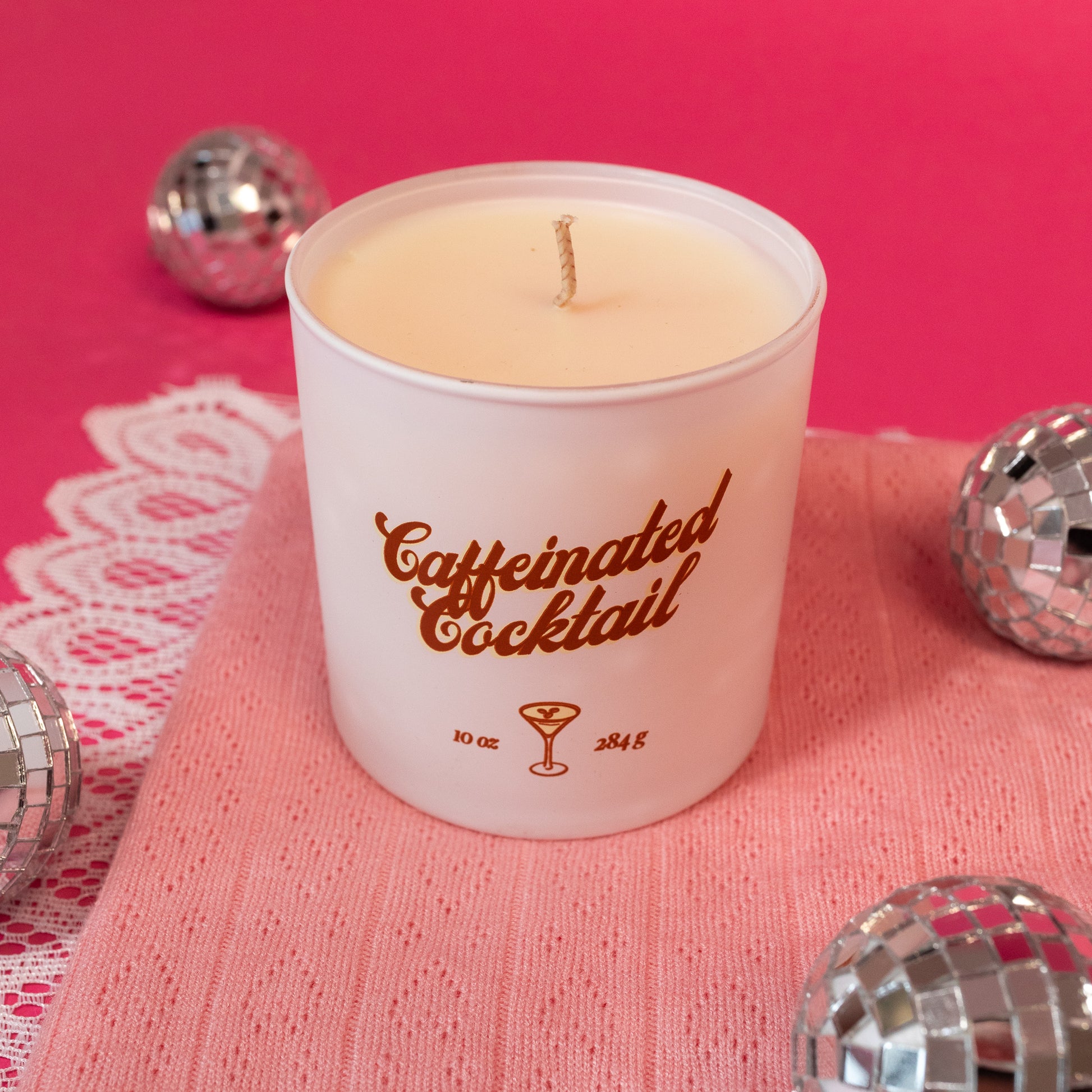 white candle with brown cursive words