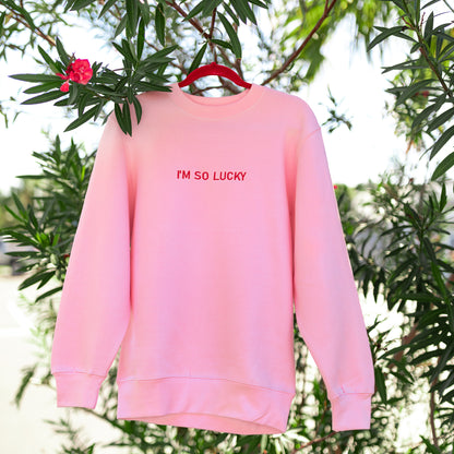 pink crew neck in green tree