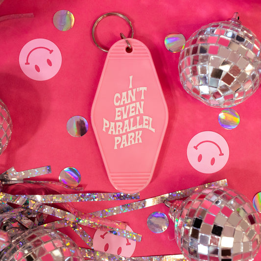 pink keychain with white words