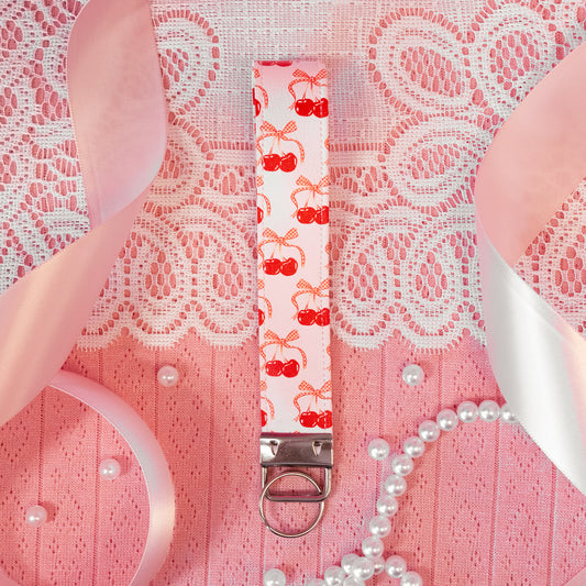 light pink wristlet keychain with red cherries