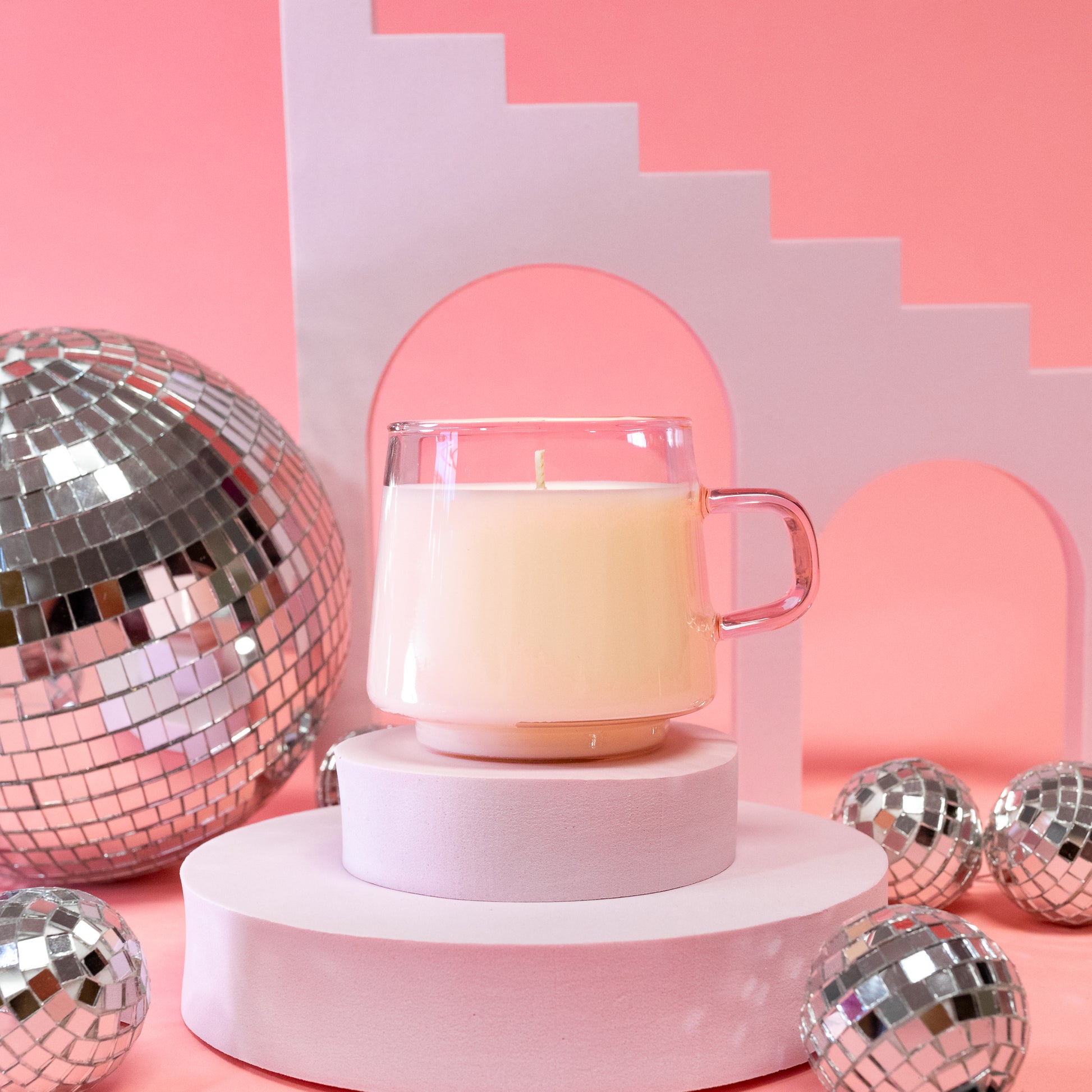 pink candle with disco balls