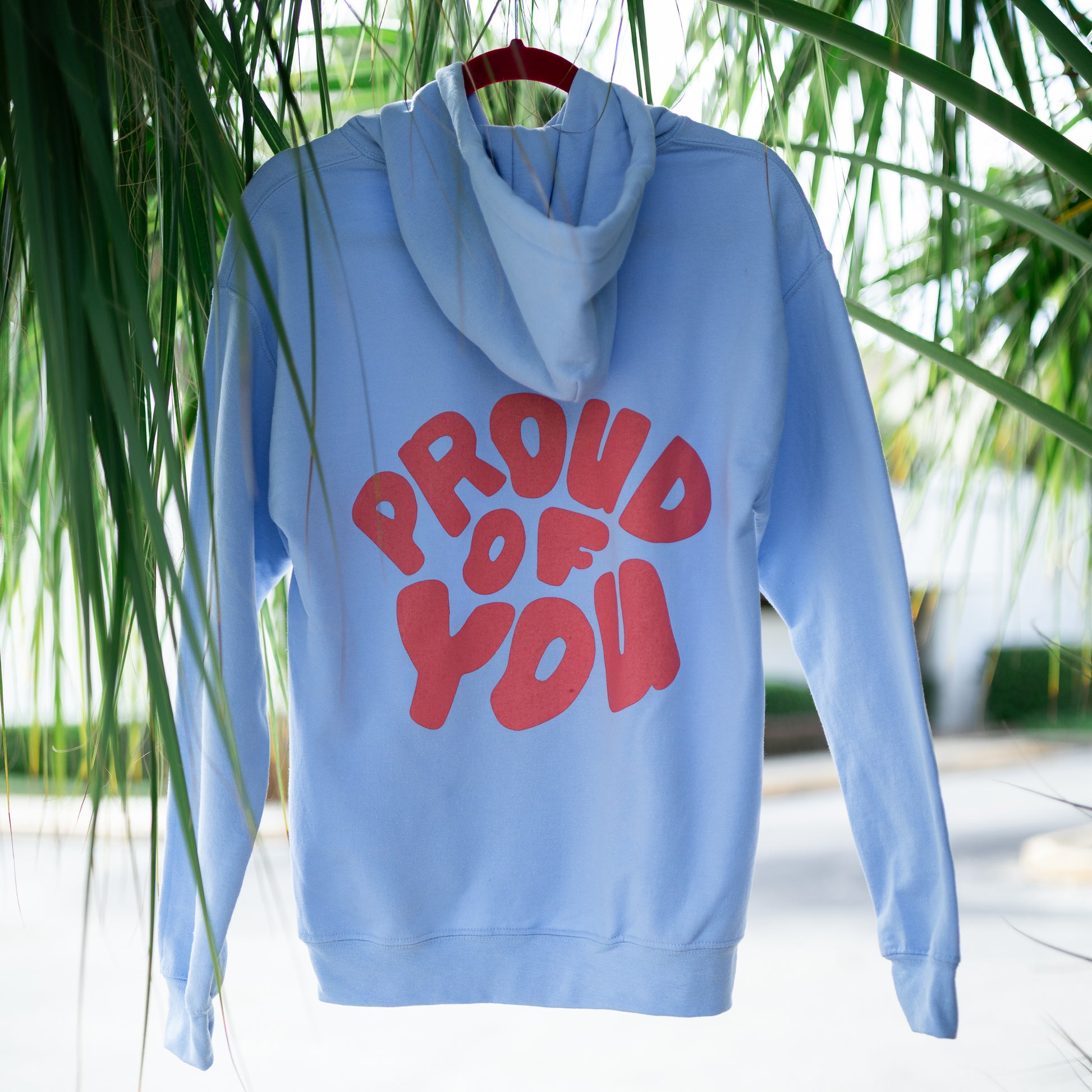 blue hoodie with pink writing proud of you
