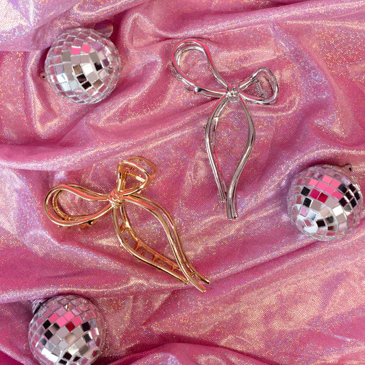 silver and gold clips with pink background