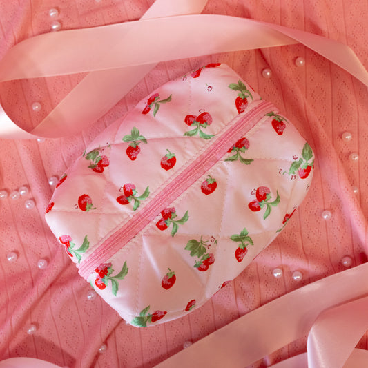 light pink pouch with red strawberries