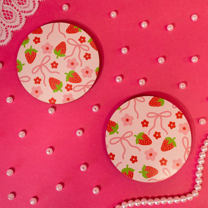 bows and strawberries on light pink coaster