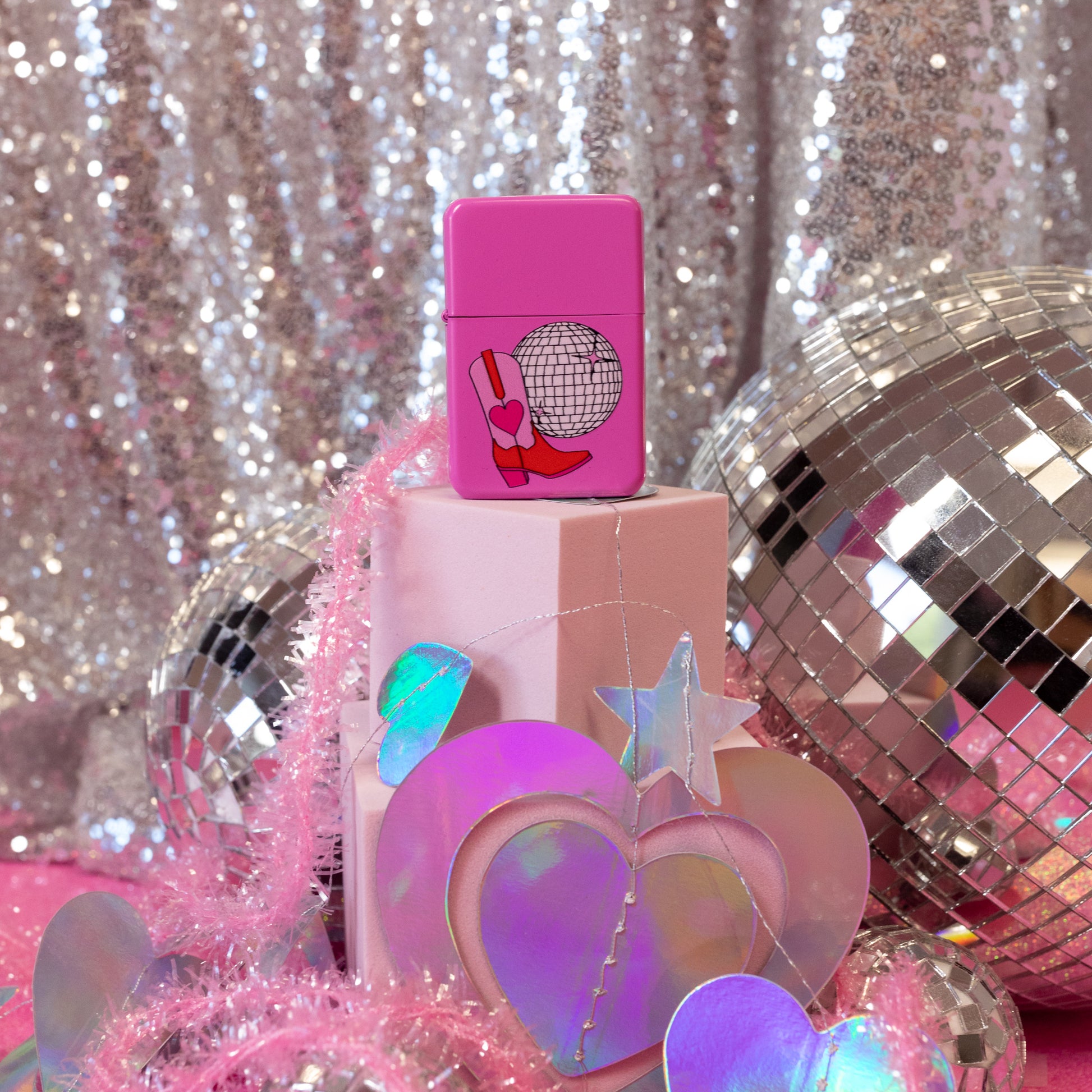 pink lighter with disco ball and boot