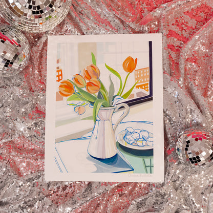 white vase with orange tulips and blue muffins art print