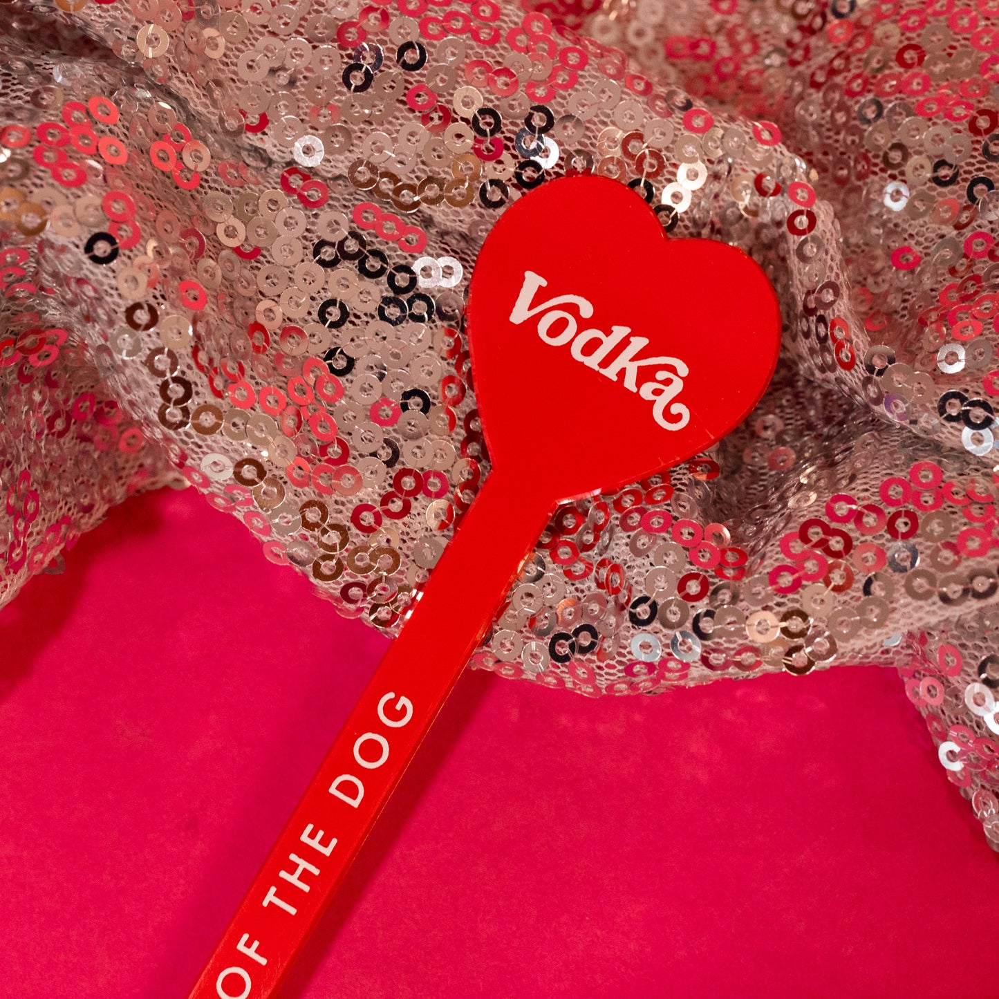 red heart stick with vodka in white lettering