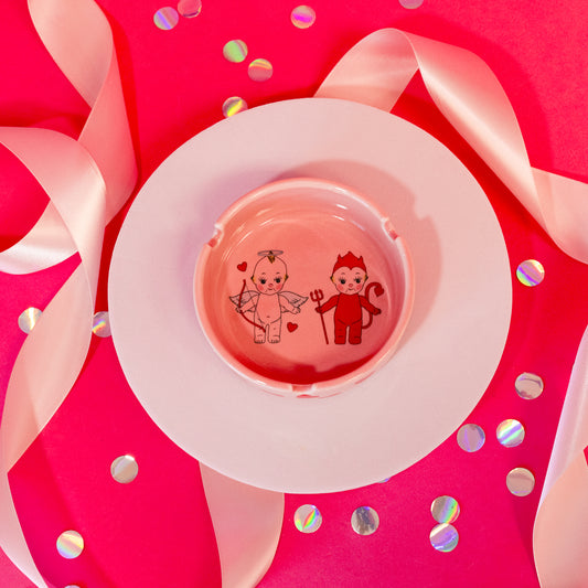 pink dish with angel and devil