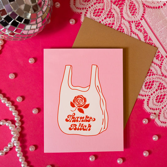 pink card with white and red bag