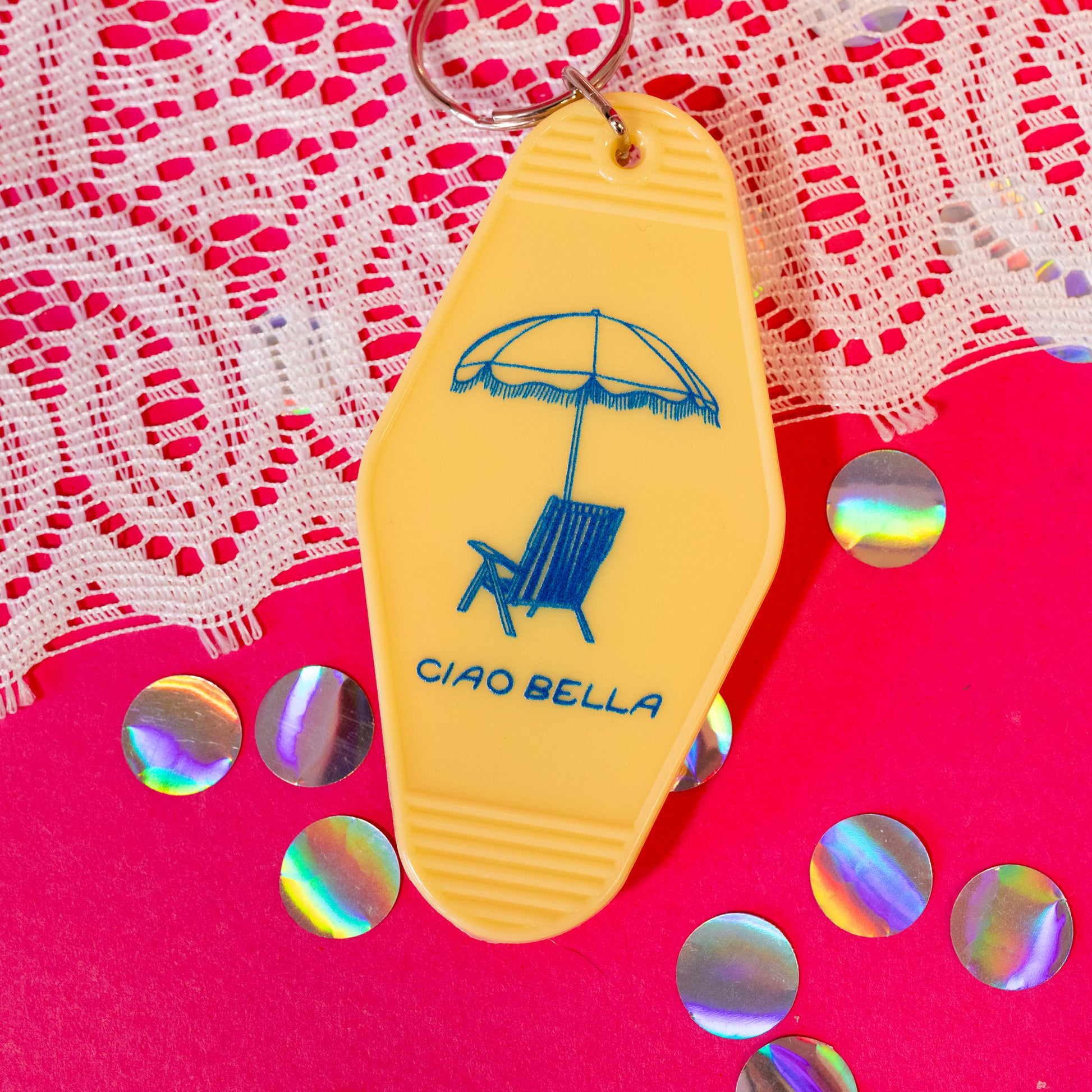 yellow keychain with blue lounge chair and umbrella