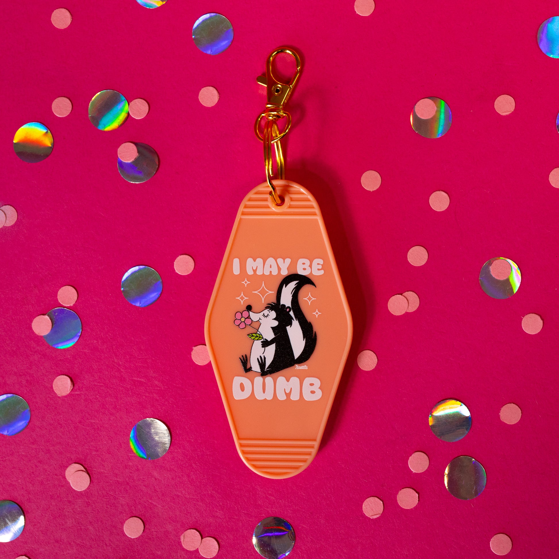 orange keychain with skunk