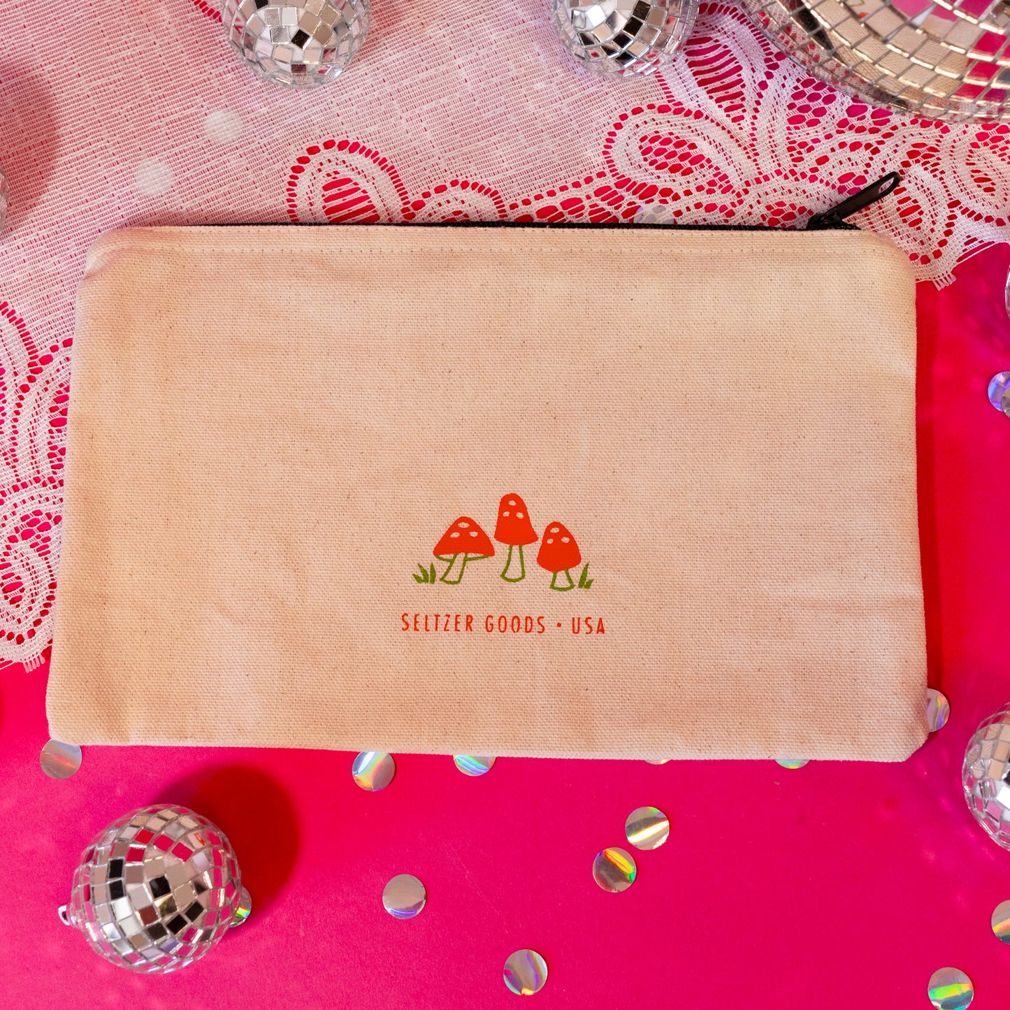 beige pouch with red mushrooms