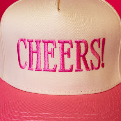 beige hat with pink cheers