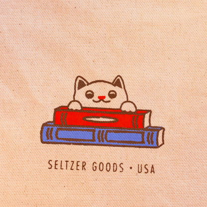 blue and red books with cat