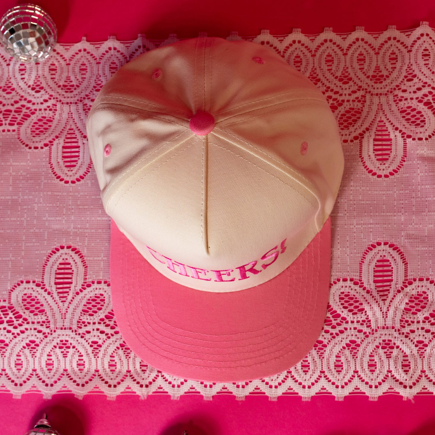 beige hat with pink stitching 
