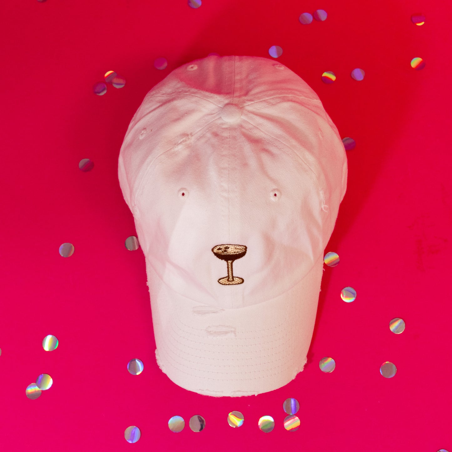 white baseball cap with brown embroidered cocktail