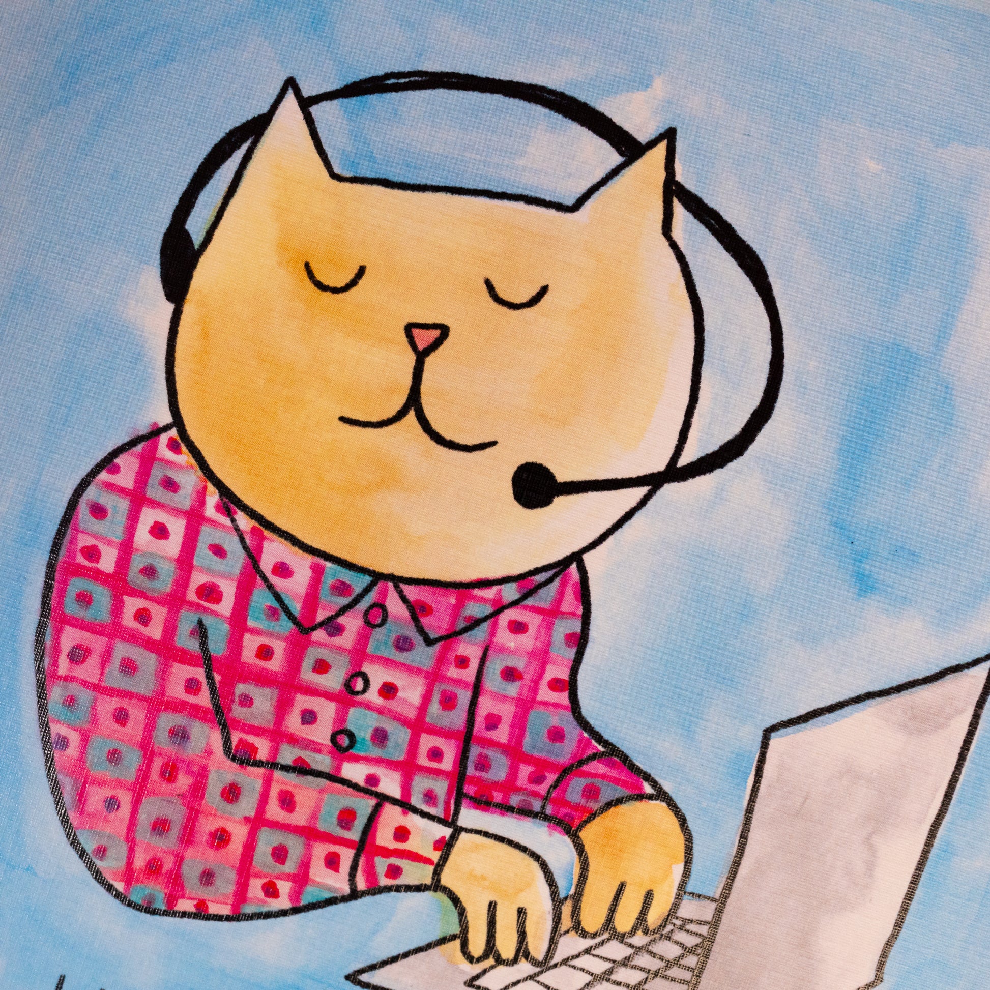 orange cat with head set wearing pink and blue shirt