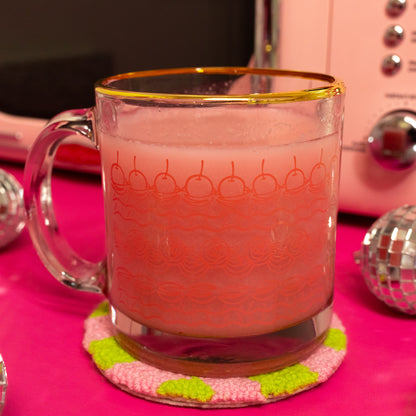 clear mug with red cake icing