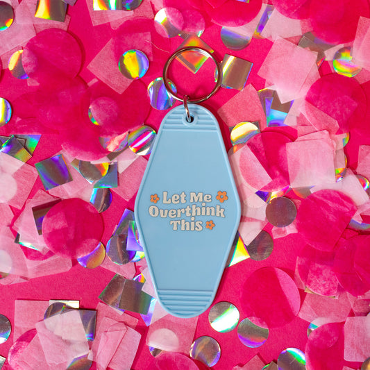 light blue keychain with white words