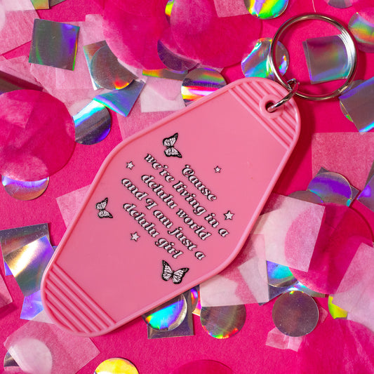 pink keychain with black and white words