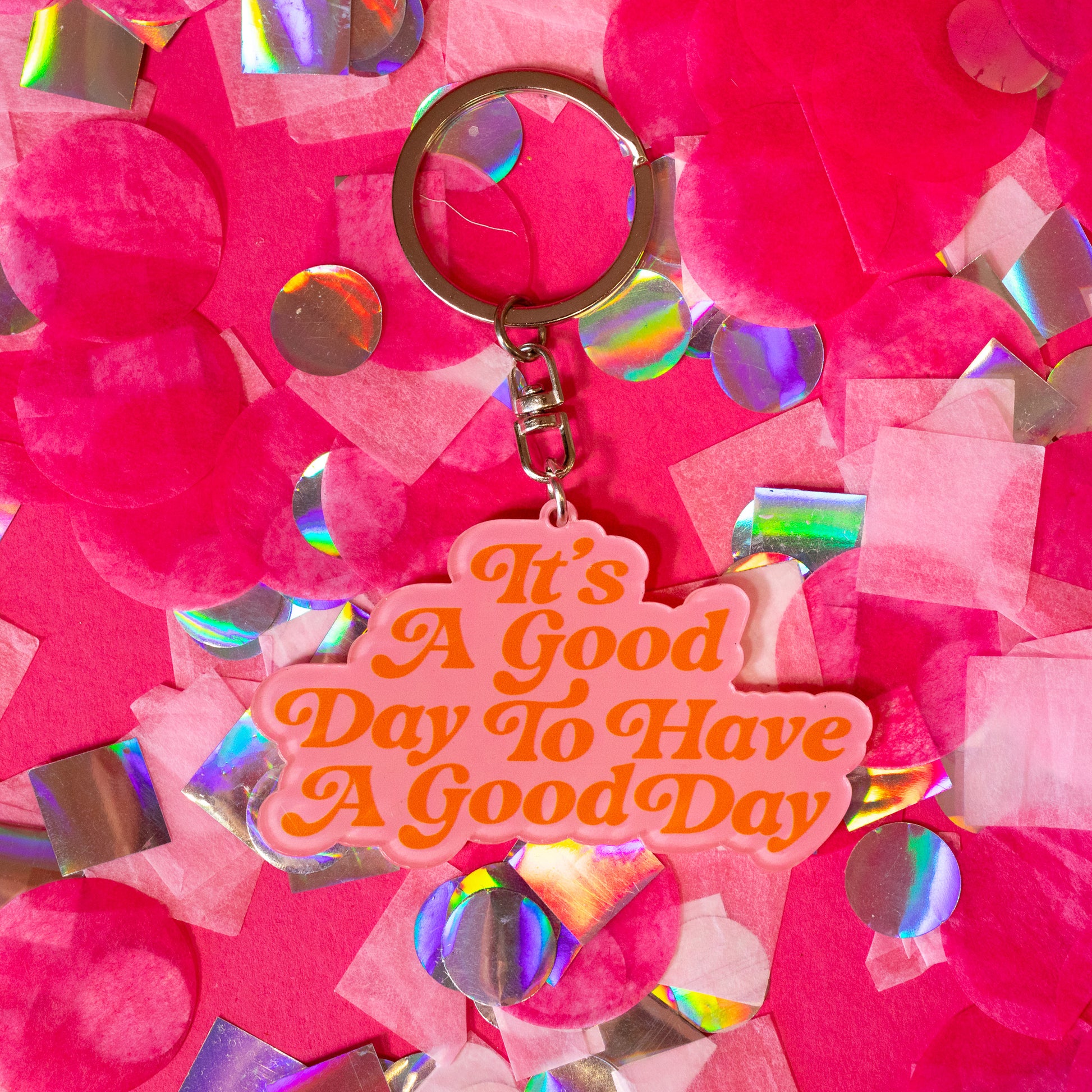 pink keychain with orange words
