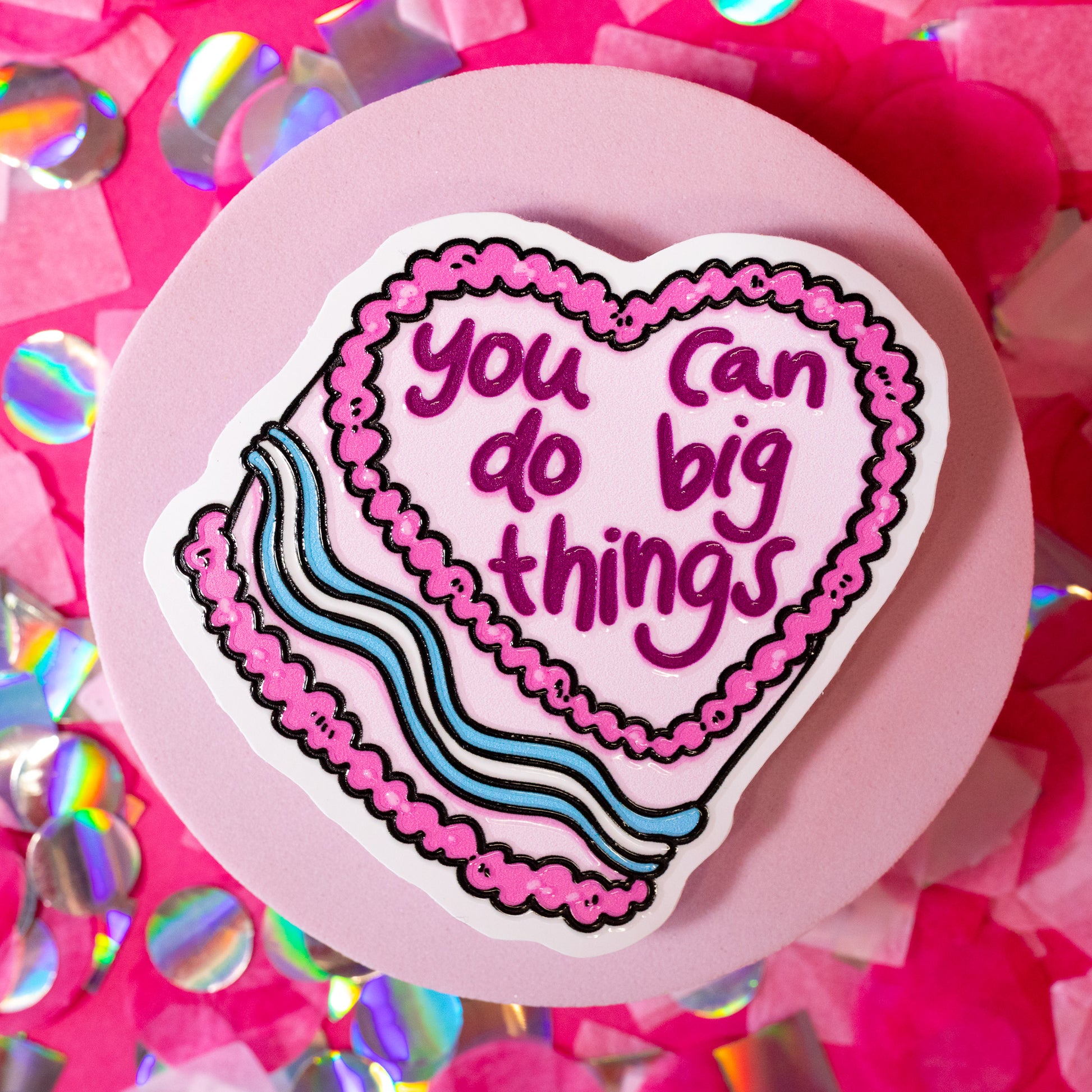 white cake sticker with pink words