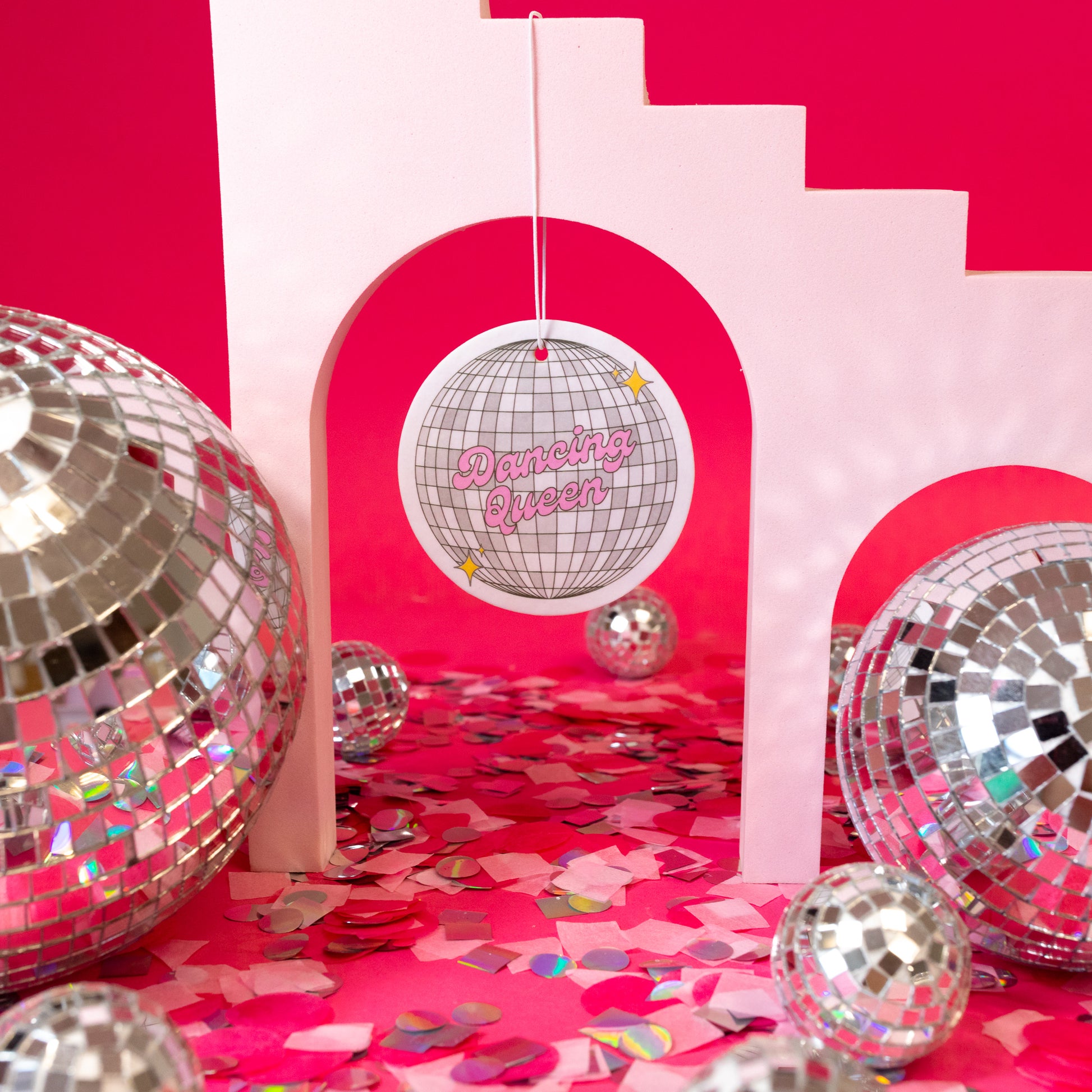 silver disco ball with pink words