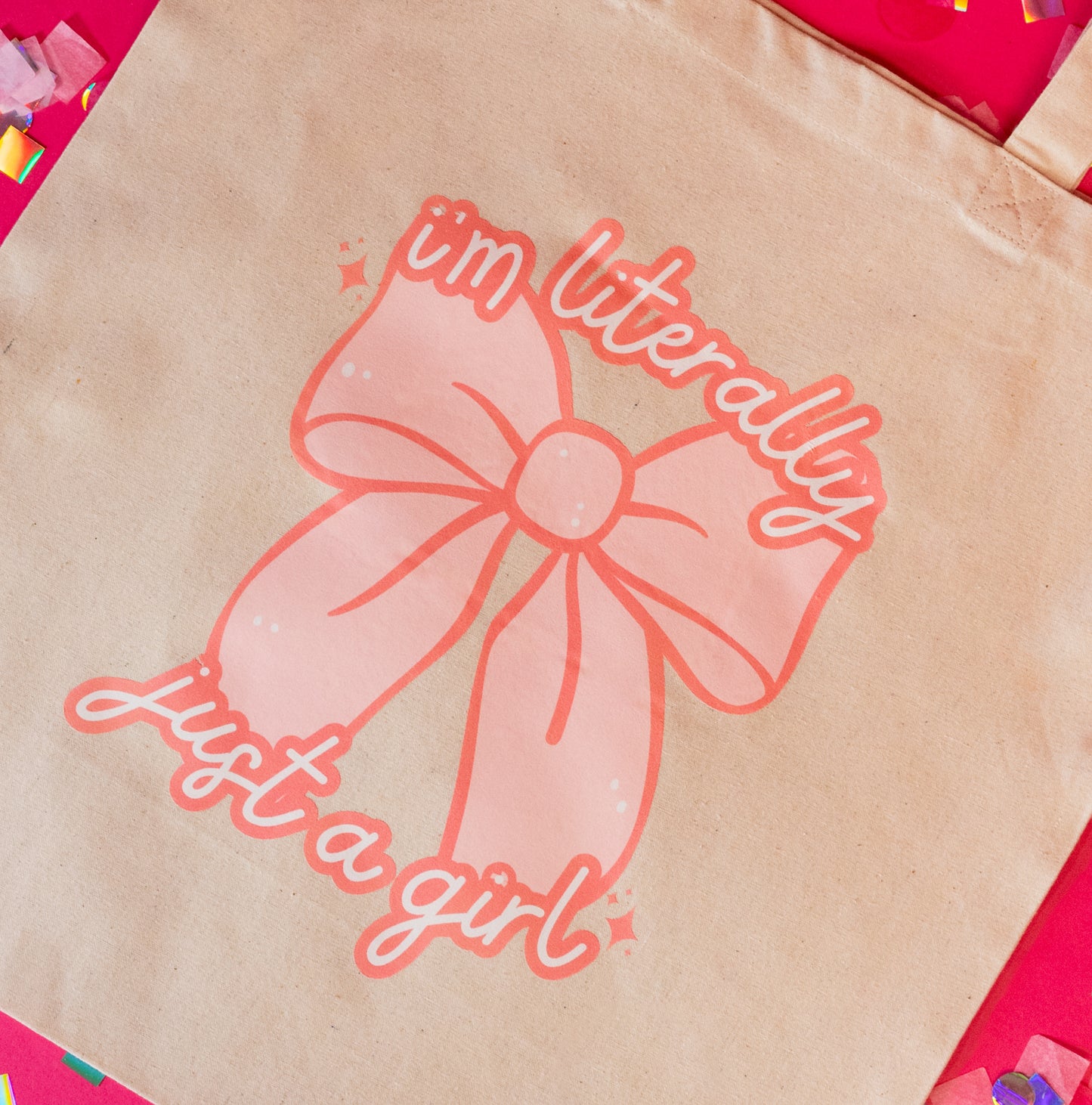 beige tote with pink bow and pink words