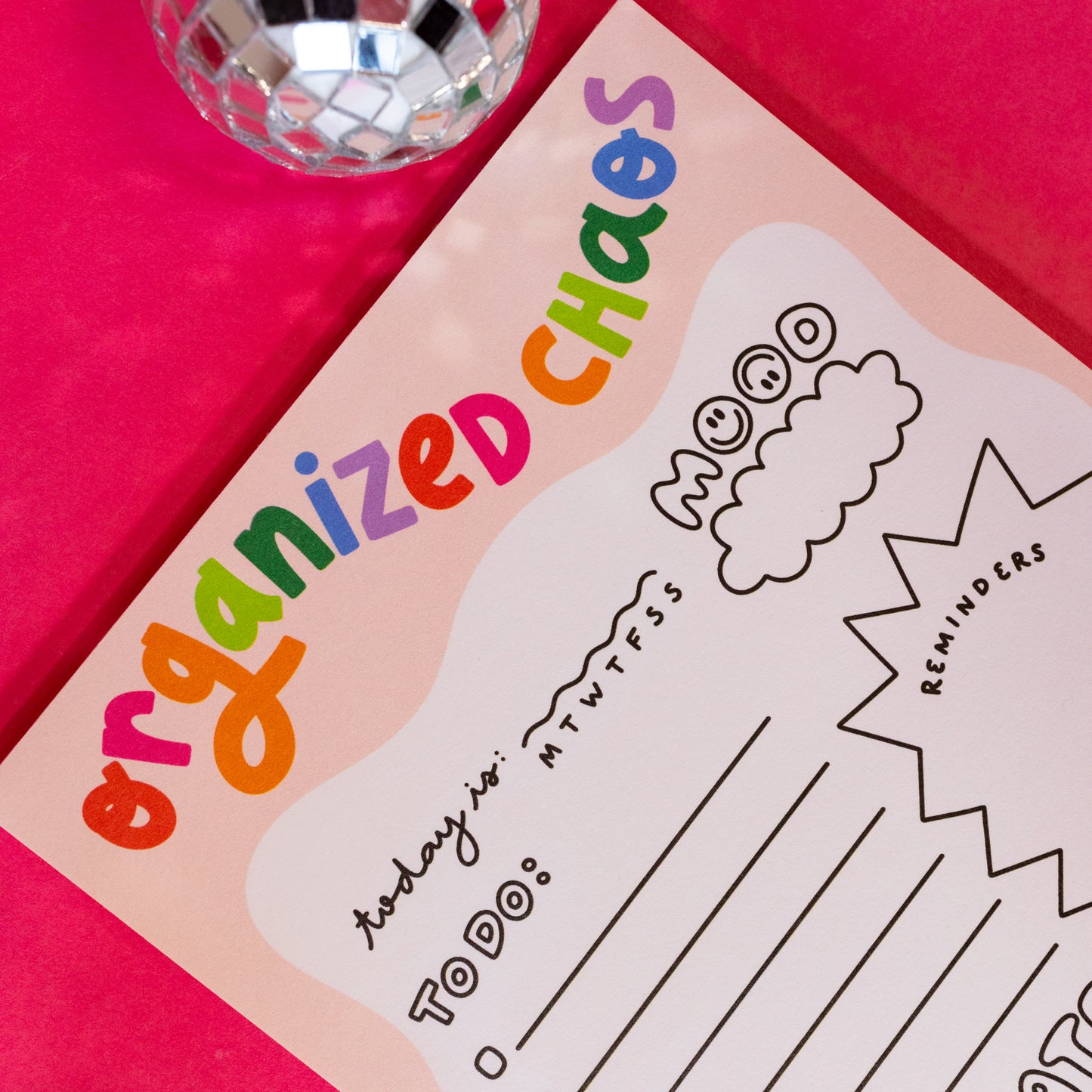 pink notepad with rainbow words