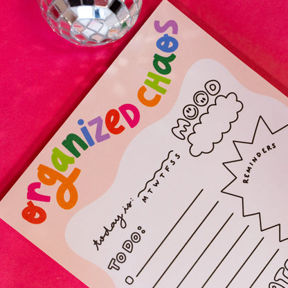 pink notepad with rainbow words
