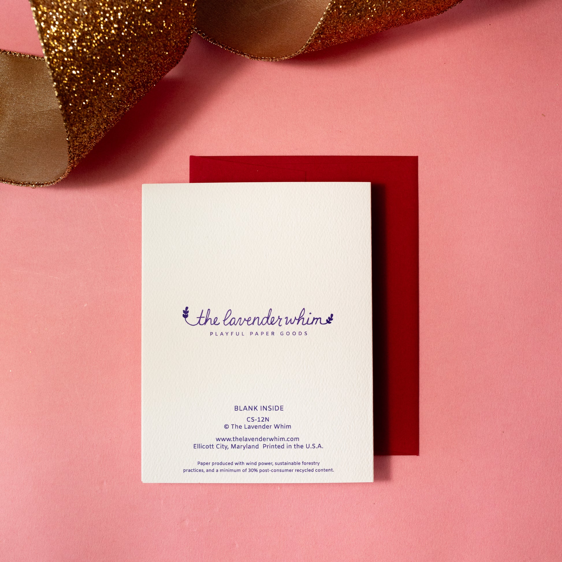 back of white card with gold ribbon