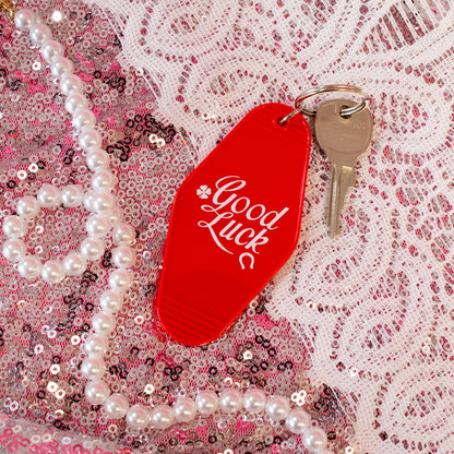 red keychain with white words