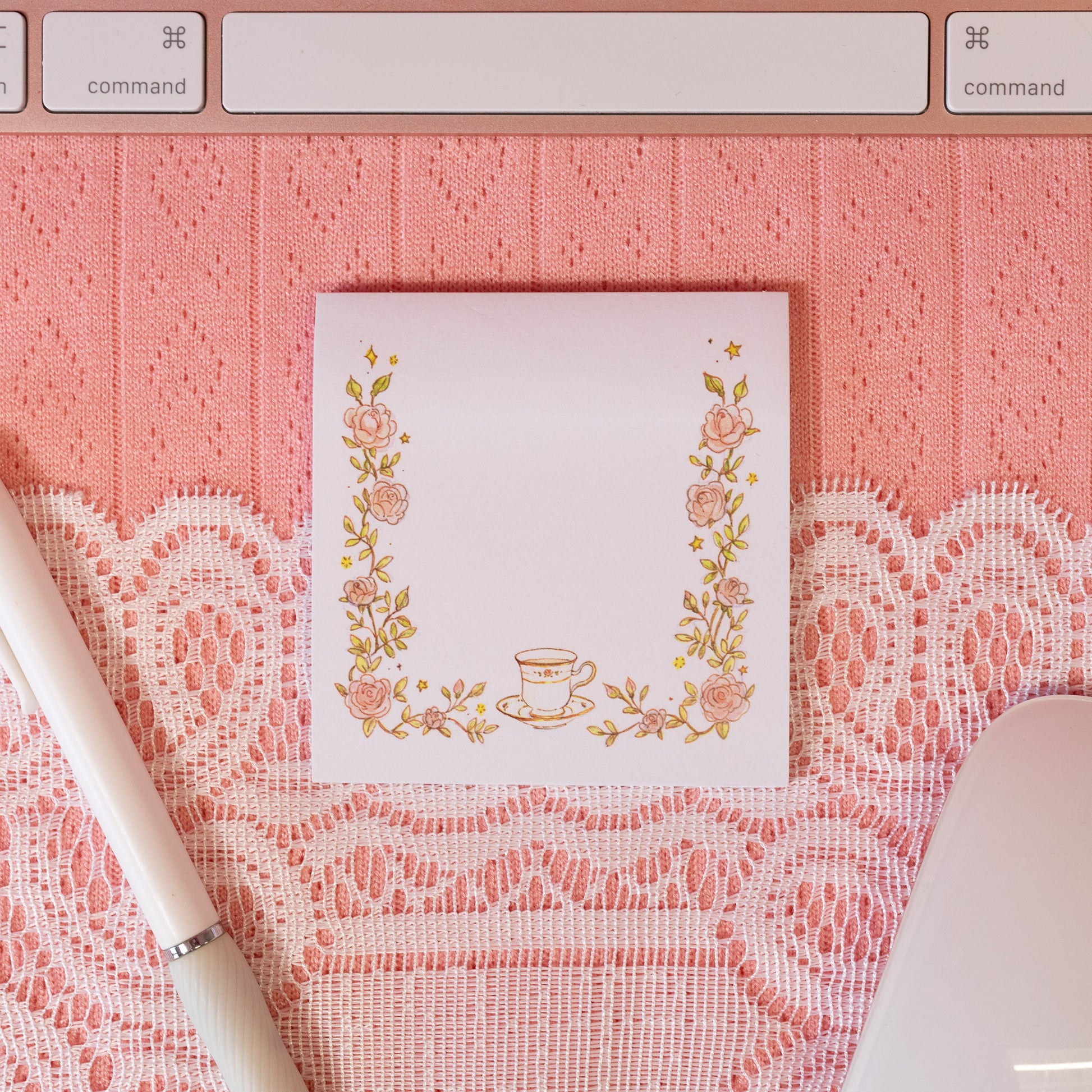 white sticky note with pink flowers