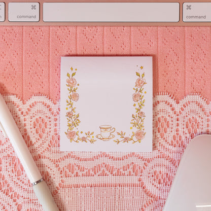 white sticky note with pink flowers